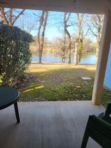 a screened porch with a view of a lake at Enolange in Monflanquin