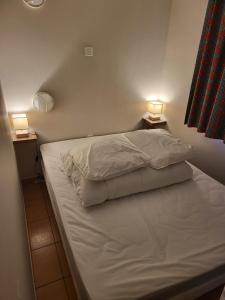 a bedroom with a bed with two lights on it at Enolange in Monflanquin +5 photos