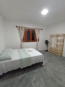 a bedroom with a bed and a window at Casa Teodoro!!! in Trairi