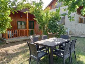 a table and chairs in front of a house at Bungalow with access to a large garden near beach in Kemer