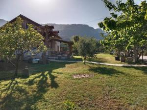 a house with a yard with trees and a building at Bungalow with access to a large garden near beach in Kemer