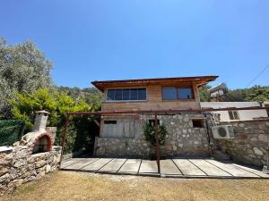 a house with a stone building with a fireplace at Faralya Villa in Fethiye