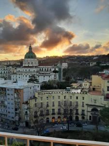a view of a city at sunset with a building at Red House in Naples