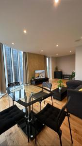 a living room with a glass table and chairs at Uxbridge Apartment in Uxbridge