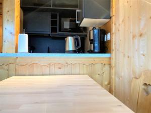 a kitchen with a wooden counter top with a table at BRELIN in Les Menuires