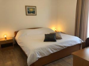 a bedroom with a bed with two pillows on it at Apartments Kankul in Krk