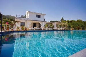 a large swimming pool in front of a house at Villa Antonella - Pool and Sea view in Castellammare del Golfo