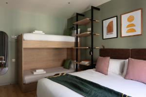 two beds in a room with two bunk beds at TOC Hotel Las Ramblas in Barcelona