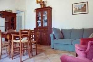 a living room with a table and a blue couch at Agriturismo Morani in Santa Severa