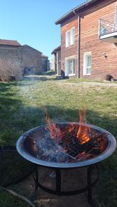 a fire pit in the middle of a yard at ferme de fenivou in Boulieu-lès-Annonay