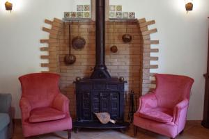 two chairs sitting next to a stove in a room at Agriturismo Morani in Santa Severa