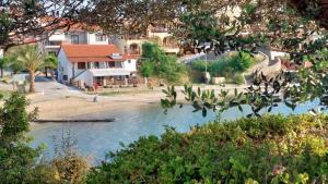 a river with a house on the side of it at IRENE traditional apartments in Ammouliani