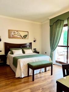 a bedroom with a large bed and a window at Los Dólmenes in Antequera