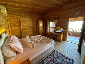 a bedroom with a bed in a wooden cabin at Faralya Villa in Fethiye