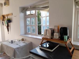 a kitchen with a table with a microwave and a window at My Little Studio in Farmborough
