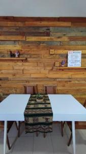 a table with two white benches and a wall at Namiva lll in Cordoba +7 photos