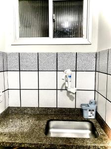 um lavatório de casa de banho com uma janela e um WC em Flat Aeroporto vitoria em Vitória