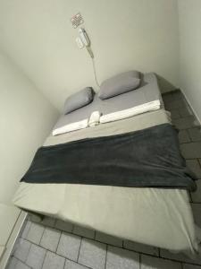 Bett in einer Ecke eines Zimmers in der Unterkunft Flat Aeroporto vitoria in Vitória