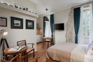 a bedroom with a bed and a table and chairs at Photel studio Apartments in Crikvenica
