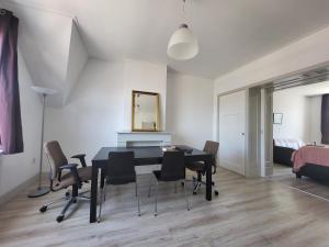 a dining room with a black table and chairs at Beautiful spacious appartment at top location The Hague in The Hague