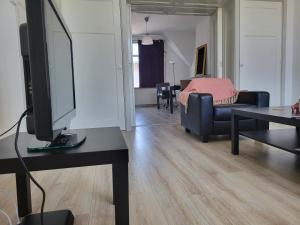 een woonkamer met een tv op een tafel bij Beautiful spacious appartment at top location The Hague in Den Haag