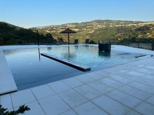 a swimming pool with a view of a mountain at Quinta Das Quintas & Spa in Baião