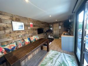a room with a wooden wall with a bench at Eddies Lodge & Spa 3 bedroom cottage in Dungiven