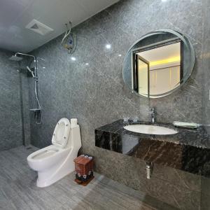 a bathroom with a sink and a toilet and a mirror at Amazing View Homestay in Ninh Binh