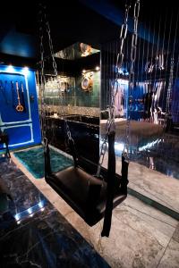 a swing in a room with a aquarium at Grey Aqua Secret Apartament in Gdańsk