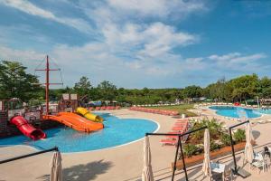 a large water park with a slide and slides at Drago Tours LODGE TENT Holiday Deluxe, Lanterna in Poreč