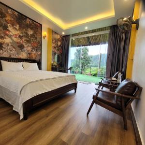 a bedroom with a bed and a chair and a window at Amazing View Homestay in Ninh Binh