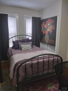 a bedroom with a bed with purple sheets and pillows at Pleasant 2br apartment in Cambridge in Cambridge