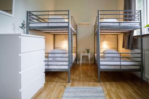 a bedroom with three bunk beds in a hostel at Kalvs Skolhus in Kalv