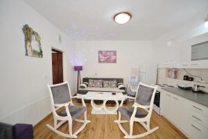 a kitchen and a living room with a table and chairs at Apartman Stefan in Kotor +8 photos