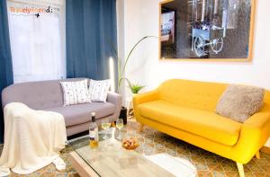 a living room with two couches and a table at GS Superb apartment with public garage in Santiago de Compostela