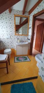 a bathroom with a sink and a tub and a toilet at Dei della Costiera 2 in Agerola