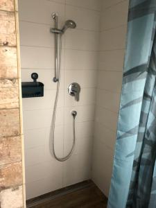a shower with a shower head and a shower curtain at Charmantes Fachwerkhaus in der Innenstadt in Minden