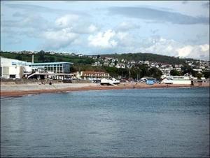 a body of water with a beach and a city at Coombe Lodge Holiday Flats in Paignton