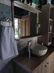 a bathroom with a sink and a white towel at Μουριές in Kamariótis