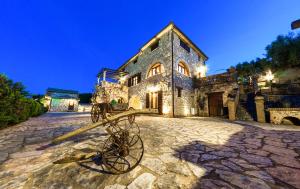 a bike parked in front of a stone building at Villa Poseidon Residence in Skinária