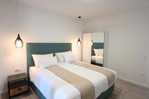 a bedroom with a large bed and a mirror at Apartment Mina Dream in Jelsa