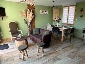a living room with a couch and a table at Gite Le Long de l'eau in Long