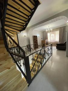 a living room with a staircase in a house at Hotel Shina in Kazbegi