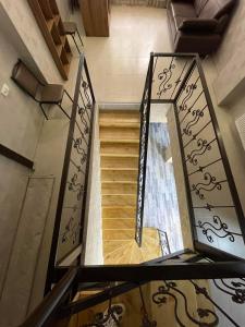 a staircase in a house with a mirror at Hotel Shina in Kazbegi