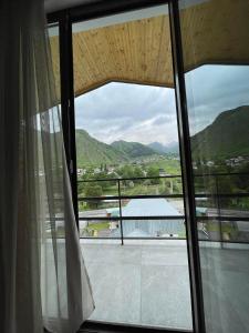 a window with a view of a mountain view at Hotel Shina in Stepantsminda