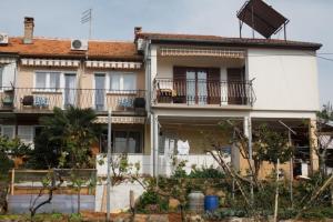 un grande edificio bianco con balconi in cima di Lino Apartments a Rovigno (Rovinj)
