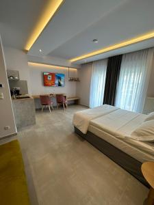 a large bedroom with a large bed and a kitchen at Meteora Gold and Glass in Kalabaka
