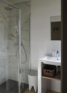 a white bathroom with a shower and a sink at songes d été 6 in Bonifacio