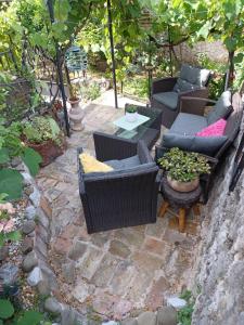 a patio with couches and a table and chairs at BAKITA in Rijeka