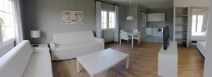 a living room with a white couch and a table at HG Jardín de Menorca in Son Bou